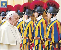  ??  ?? Pope Francis with the Swiss Guards at the Vatican.