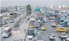  ?? — Reuters ?? Traffic moves in front of a wholesale market, in eastern Mosul, Iraq.