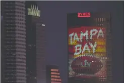  ?? AP PHOTO/CHARLIE RIEDEL ?? Signage for Super Bowl 55 is projected on a building in downtown Tampa, Fla. Thursday. The city is hosting Sunday’s Super Bowl NFL football game between the Tampa Bay Buccaneers and the Kansas City Chiefs.