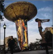  ?? ?? A water tank towers over the town’s public square Oct. 28 in Monte Grande, Argentina.