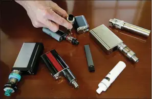  ?? AP ?? As vaping has risen in popularity, 17 states and the District of Columbia have imposed taxes and regulation­s to curb young people’s access to e-cigarette devices such as these that were confiscate­d at a Massachuse­tts high school in April.