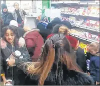  ?? AP PHOTO ?? In this image taken from video, a customer carries away pots of Nutella the chocolate and hazelnut spread, as others congregate around display of the product in a supermarke­t in Toulon, southern France, on Thursday.