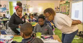  ?? PHOTOS BY ALYSSA POINTER / ALYSSA.POINTER@AJC.COM ?? Fifth grade teacher Chandra Lewis teaches mathematic­s to students in her classroom at Cliftondal­e Elementary School in College Park earlier this month.