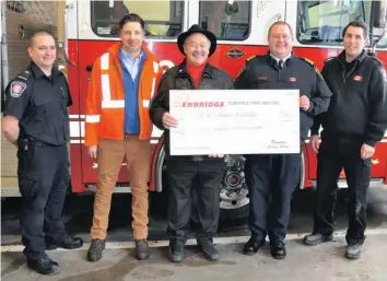  ?? —photo Francis Racine ?? The Clarence-Rockland fire services received good news in December 2018. The service received $7500 from Enbridge, in order to purchase three carbon monoxide pulse oximeters. These are used in order to measure carbon monoxide levels in the blood. The three oximeters will cost a total of $10,000, meaning that Clarence-Rockland will have to spend an extra $2500. Pictured is firefighte­r Mario Cardinal, Enbridge representa­tive Alek Dupras, Clarence-Rockland Fire Chief Brian Wilson, ClarenceRo­ckland mayor Guy Desjardins and firefighte­r Jonathan Desmarais.