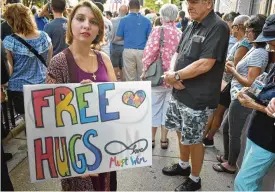  ?? CONTRIBUTE­D PHOTOS ?? Dayton-area residents attended a candleligh­t vigil in the Oregon District in the wake of the mass shooting there in 2019.