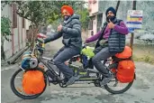  ?? — PTI ?? Men ride a modified bicycle to raise awareness about organ donation in Moradabad on Thursday.