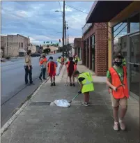  ??  ?? Pack 113 members cleaned up the area around their meeting place of Trinity United Methodist Church Tuesday evening. They adopted North 5th Avenue, West Third Street and Avenue A and periodical­ly clean up those areas with the help of Keep Rome Floyd Beautiful.