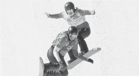  ??  ?? Comox resident Carle Brenneman, top, battles for position Friday with Belle Brockhoff of Australia during a quarter-final heat in the women’s snowboard cross event at Phoenix Snow Park. Brenneman finished fourth in the heat and failed to advance. She...