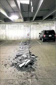  ??  ?? Concrete that fell from the first floor roof in the Cal U garage spans from the front of a parking space to the middle of the lane.