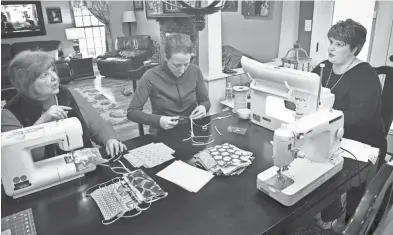  ?? LARRY MCCORMACK/THE TENNESSEAN ?? Vickie Giuvens sews with her daughters Hope Dillard and Robin Moore who decided to make a few masks to help the cause.