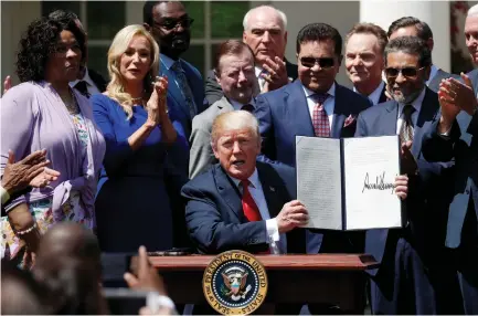  ?? (Leah Millis/Reuters) ?? US PRESIDENT Donald Trump signs an ‘Establishm­ent of a White House Faith and Opportunit­y Initiative’ proclamati­on after the National Day of Prayer ceremony at the White House earlier this month.