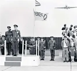  ??  ?? David Emmerson taking the salute at a passing-out parade at RAF Swinderby as a Nimrod flies over