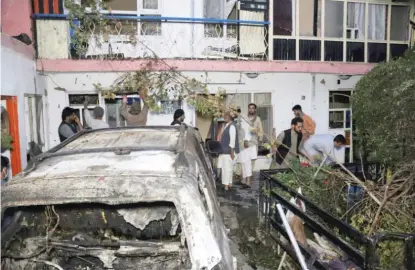  ?? AP FILE ?? Afghans inspect the damage to a home after a U.S. drone strike in Kabul, Afghanista­n, on Aug. 29. A Pentagon review of the strike found that only civilians were killed in the attack.