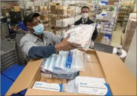  ?? RAY MANNING; RIVA SAYEGH-MCCULLEN ?? Henry Ford Health System received its initial allocation of 4,875 Pfizer COVID-19 vaccine doses on Thursday, Dec. 17, 2020. Each of the system’s five hospitals received 975 doses.