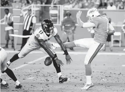  ?? WILFREDO LEE/ASSOCIATED PRESS ?? Chris Matthews of the Ravens blocks a punt by Dolphins punter Matt Darr during the first half of Thursday’s game. The block set up a touchdown by the Ravens.