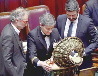  ?? — AFP ?? Chamber’s assistants open the ballot box in the Chamber of Deputies in Rome on Friday, during the first session after the March 4 vote.