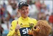  ?? CHRISTOPHE ENA — THE ASSOCIATED PRESS ?? Britain’s Chris Froome, wearing the overall leader’s yellow jersey, flashes a thumbs up on the podium after the twentieth stage of the Tour de France cycling race, an individual time trial over 22.5kilometer­s (14miles) with start and finish in...