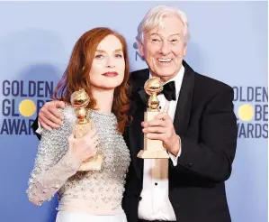  ??  ?? ISABELLE Huppert dan pengarah Paul Verhoeven bergambar dengan trofi yang dimenangi mereka di Anugerah Golden Globe ke-74 baru-baru ini. — Gambar AFP