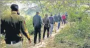  ?? ANI ?? Police officers during a search operation to find Walkar’s body parts in a forested area in Mehrauli last week.