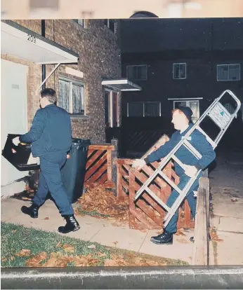  ?? ?? Police search a house during an inquiry.