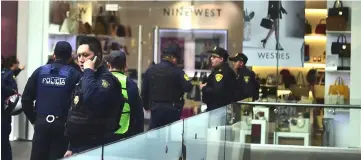  ??  ?? Police are seen at a mall in Mexico City, after a shootout in which at least one person was injured. — AFP photo