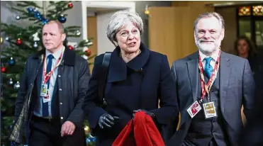  ??  ?? All smiles: May and Tim Barrow (right), UK permanent representa­tive to the European Union leaving after attending a European Union leaders summit in Brussels, Belgium. — Bloomberg