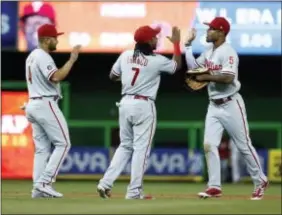  ?? WILFREDO LEE — THE ASSOCIATED PRESS ?? Phillies Nick Williams (5), Maikel Franco (7) and Andres Blanco (4) celebrate after beating the Marlins 2-1 Friday in Miami.
