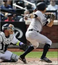  ?? FRANK FRANKLIN II — THE ASSOCIATED PRESS ?? New York Yankees' Brett Gardner follows through on a two-run single during the second inning of a baseball game as Tampa Bay Rays catcher Jesus Sucre, left, watches Wednesday in New York.