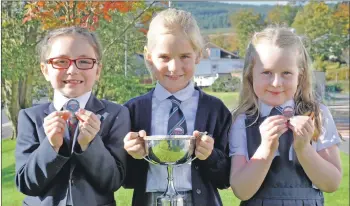  ?? 15_MOD42DM5_poetry ?? Millie Bonniwell, middle, Bun-sgoil Achadh na Creige, (Rockfield, Oban) won the learners 7-8 years prescribed poetry competitio­n and was second in the 7-8 years learners singing. Classmate Esme McLeod, right, was third and Niamh McCrudden from Glasgow, left, was second. Esme was also first in the conversati­on 5-8 years learners and Niamh was second.