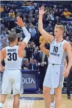  ?? JOURNAL SENTINEL ?? Andrew Rowsey and Sam Hauser celebrate a Marquette score Wednesday night.