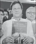  ?? AFP ?? n Imran Khan with his party’s manifesto