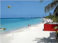  ?? ISTHATITSM­E / BUDGET TRAVEL ?? Jet-skiers and sunbathers enjoy Seven Mile Beach in Negril.