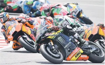  ??  ?? Monster Yamaha Tech 3 team Malaysian rider Hafizh Syahrinz (R) negotiates a corner during the Malaysia MotoGP at the Sepang Internatio­nal Circuit in Sepang. — AFP photo