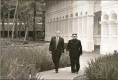  ?? REUTERS ?? US President Donald Trump and North Korean leader Kim Jong Un walk outside the Capella Hotel after their working lunch, Sentosa island, Singapore, June 12