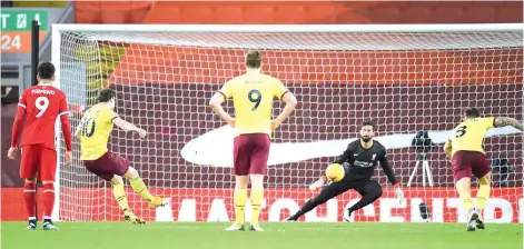  ?? - AFP photo ?? Burnley's English striker Ashley Barnes (2L) scores the opening goal from the penalty spot against Liverpool at Anfield in Liverpool.