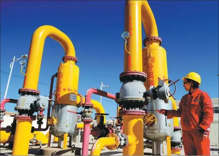  ?? CHINA NEWS SERVICE ?? A technician checks equipment at China Petrochemi­cal Corporatio­n’s coalbed methane field in Yanchuan, Shaanxi province.