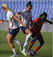  ?? ?? The United States’ Mallory Pugh, center, and Sherly Jeudy of Haiti battle for the ball during Monday’s CONCACAF W Championsh­ip opening match in Monterrey, Mexico.