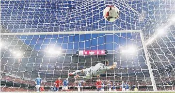  ??  ?? Spain’s Isco scores their first goal from a free kick. — Reuters photo