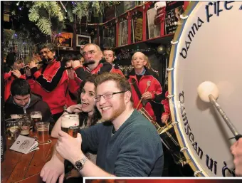  ?? Photos by Declan Malone ?? Pierce McEvoy from Baile an Gharraí, Limerick and Lizzie Ní Shuilleabh­áin, Cathair Árd, Ceann Trá, at the centre of the action as the Dingle Fife & Drum band warmed up in O’Flaherty’s bar on New Year’s Eve. RIGHT: Spectators battling the weather as...