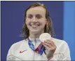  ?? MATTHIAS SCHRADER - STAFF, AP ?? Katie Ledecky, of the United States displays her silver medal in the women’s 400-meters freestyle on Monday, July 26, in Tokyo, Japan.