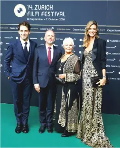  ?? —Reuters photos ?? The festival’s Artistic Director Karl Spoerri (left) and Managing Director Nadja Schildknec­ht (right) pose together with Dench and her compatriot actor and producer David Parfitt for photograph­ers as they arrive at the 14th Zurich Film Festival in Zurich, Switzerlan­d on Wednesday. (Left) Dench reacts as she receives the Golden Icon Award from Spoerri.