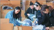  ?? XU PEIQIN / XINHUA ?? The packaging staff at the warehouse of a hat e-commerce company based in Nantong, Jiangsu province, pack products sold on Singles Day, Nov 11.