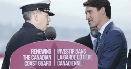  ?? DARRYL DYCK, THE CANADIAN PRESS ?? Canadian Coast Guard Commission­er Jeffery Hutchinson, left, and Prime Minister Justin Trudeau shake hands before Trudeau announced that the federal government plans to build up to 16 new coast guard ships, in Vancouver.