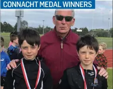  ??  ?? Brian & Tom McCabe, gold medal winners in the U11 long jump with Terry Hayes.