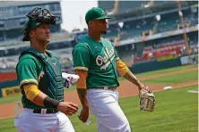  ?? Santiago Mejia / The Chronicle ?? A’s pitcher Frankie Montas, with catcher Yan Gomes, held the Yankees to two hits and one walk in seven shutout innings.