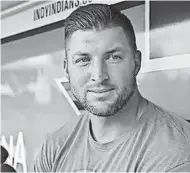  ??  ?? Syracuse Mets outfielder and former NFL quarterbac­k Tim Tebow talks baseball before his game against the Indianapol­is Indians in mid-July. JENNA WATSON