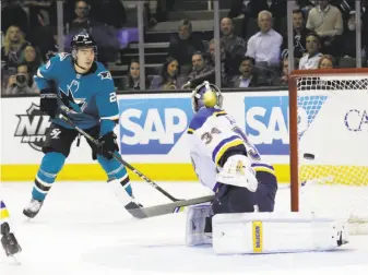  ?? Marcio Jose Sanchez / Associated Press ?? Timo Meier watches a shot by teammate Mikkel Boedker slip past Blues goalie Jake Allen. Until the goal, the Sharks had failed to score on a team-record 29 consecutiv­e power plays.