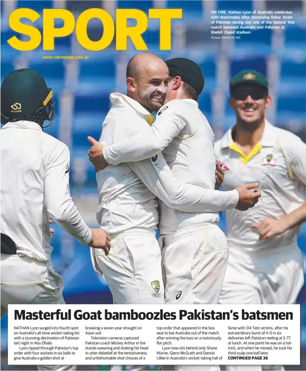  ?? Picture: FRANCOIS NEL ?? www.cairnspost.com.au ON FIRE: Nathan Lyon of Australia celebrates with teammates after dismissing Babar Azam of Pakistan during day one of the Second Test match between Australia and Pakistan at Sheikh Zayed stadium.