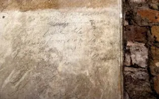  ??  ?? Above: Pencil graffiti saying that “Tom Porter was very fond of Ould Ale” dated August 11 1851 records men who restored the cloisters when the passageway was closed