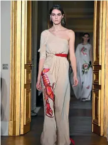  ?? PHOTOS: REUTERS/SUPPLIED ?? Wallis Simpson caused a sensation when she debuted Elsa Schiaparel­li’s ‘‘Lobster Dress’’ 80 years ago, and a new version was one of the highlights of a show in Paris celebratin­g the brand’s return to the world of haute couture.